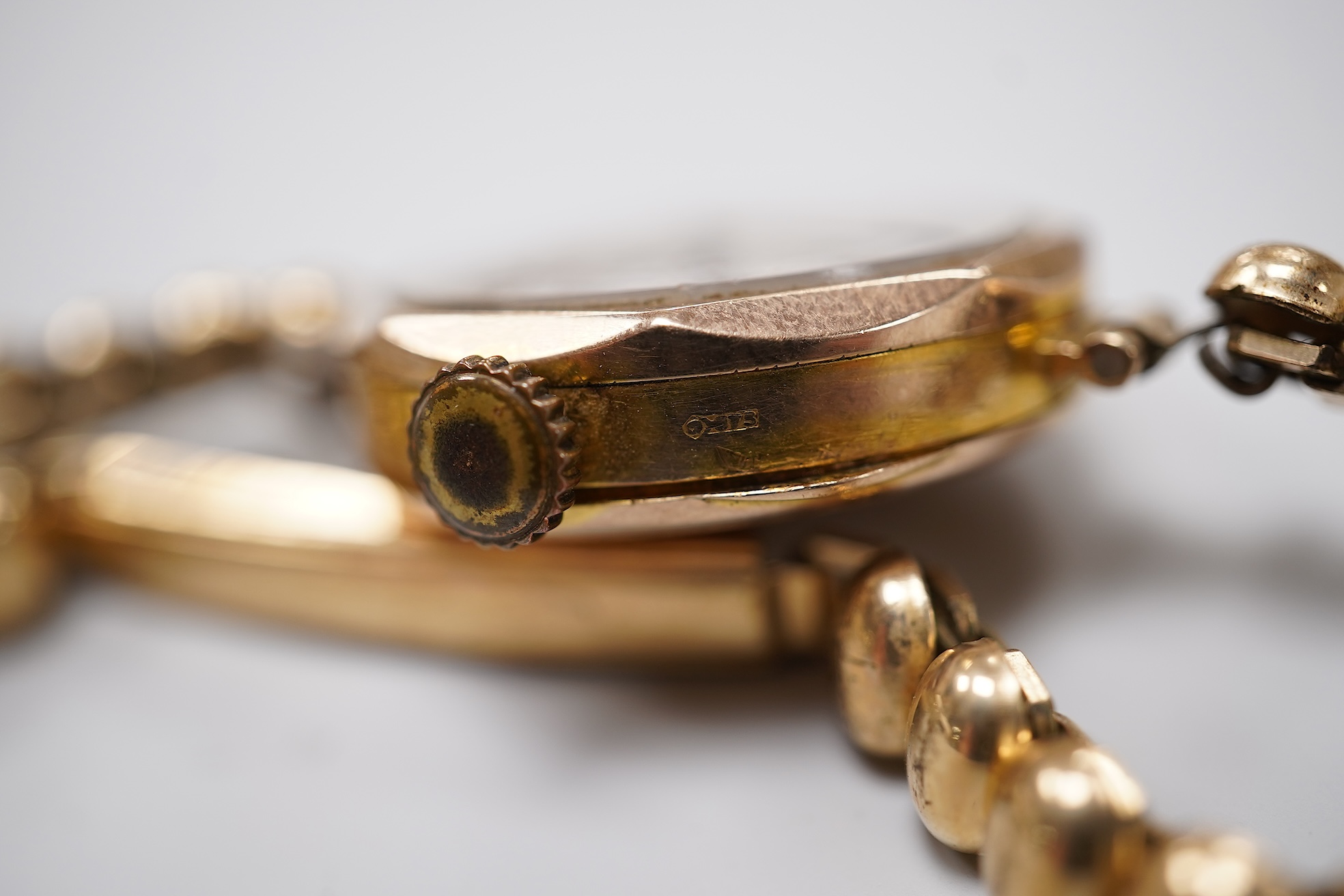 A lady's 9ct Omega manual wind wrist watch, on an associated leather strap, case diameter 20mm, together with a lady's early 20th century 9ct gold Rolco manual wind wrist watch, on a rolled gold bracelet.